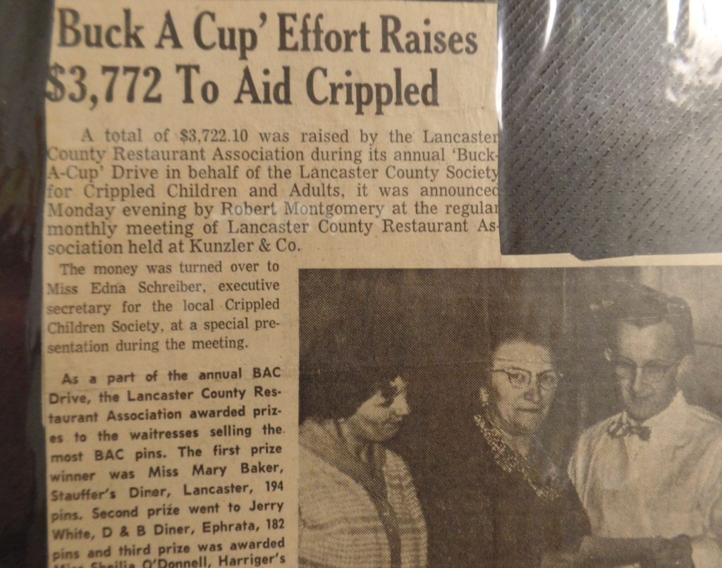 Image shows a news paper article
Headline reads: Buck A Cup Effort Raises ,772 To Aid Crippled