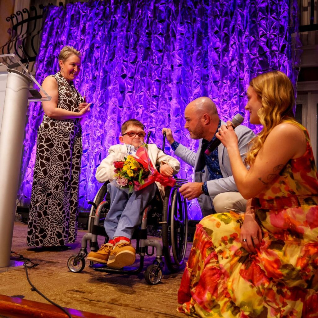 ambassador and his family on stage for speech at 2025 gala