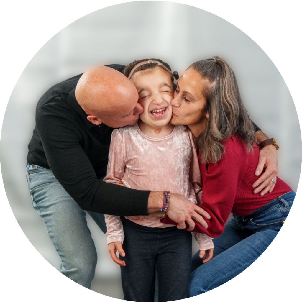Parents hugging and kissing little girl