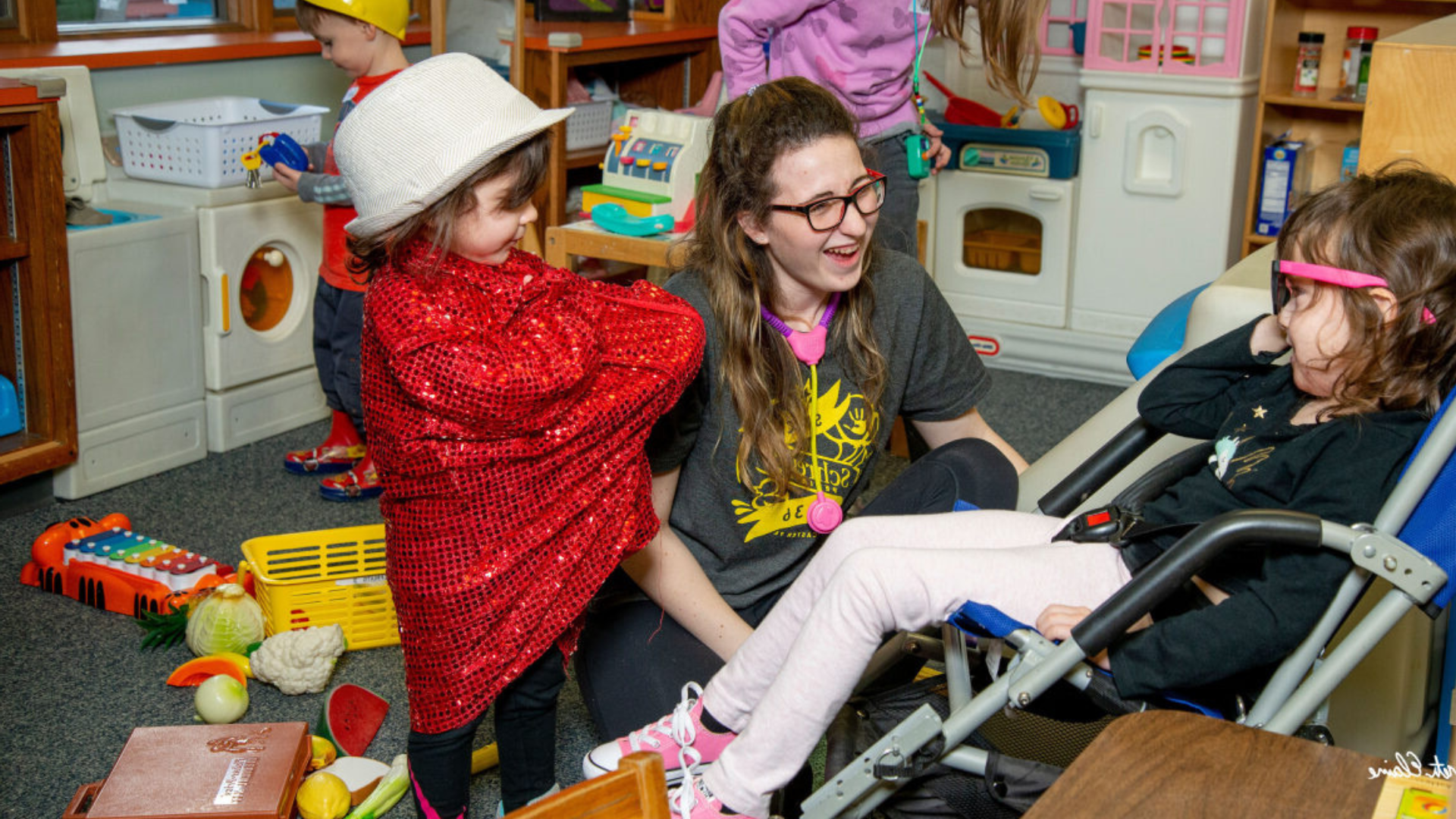 young woman playing with two small children