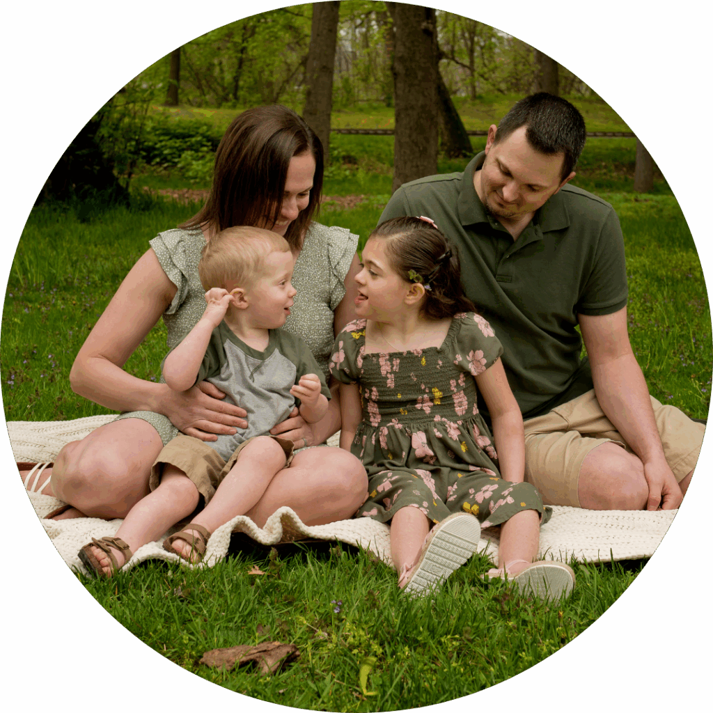 Mom, dad, daughter, and son sitting on a picnic blanket