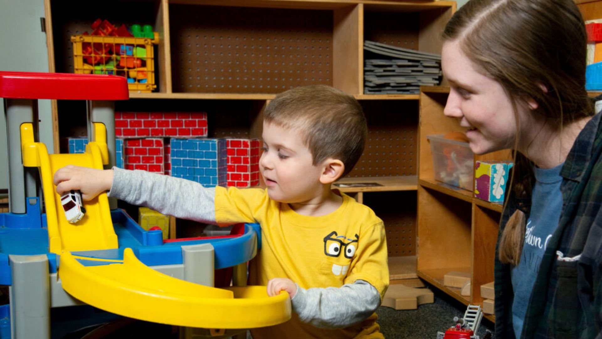 Respite night kiddo and volunteer playing