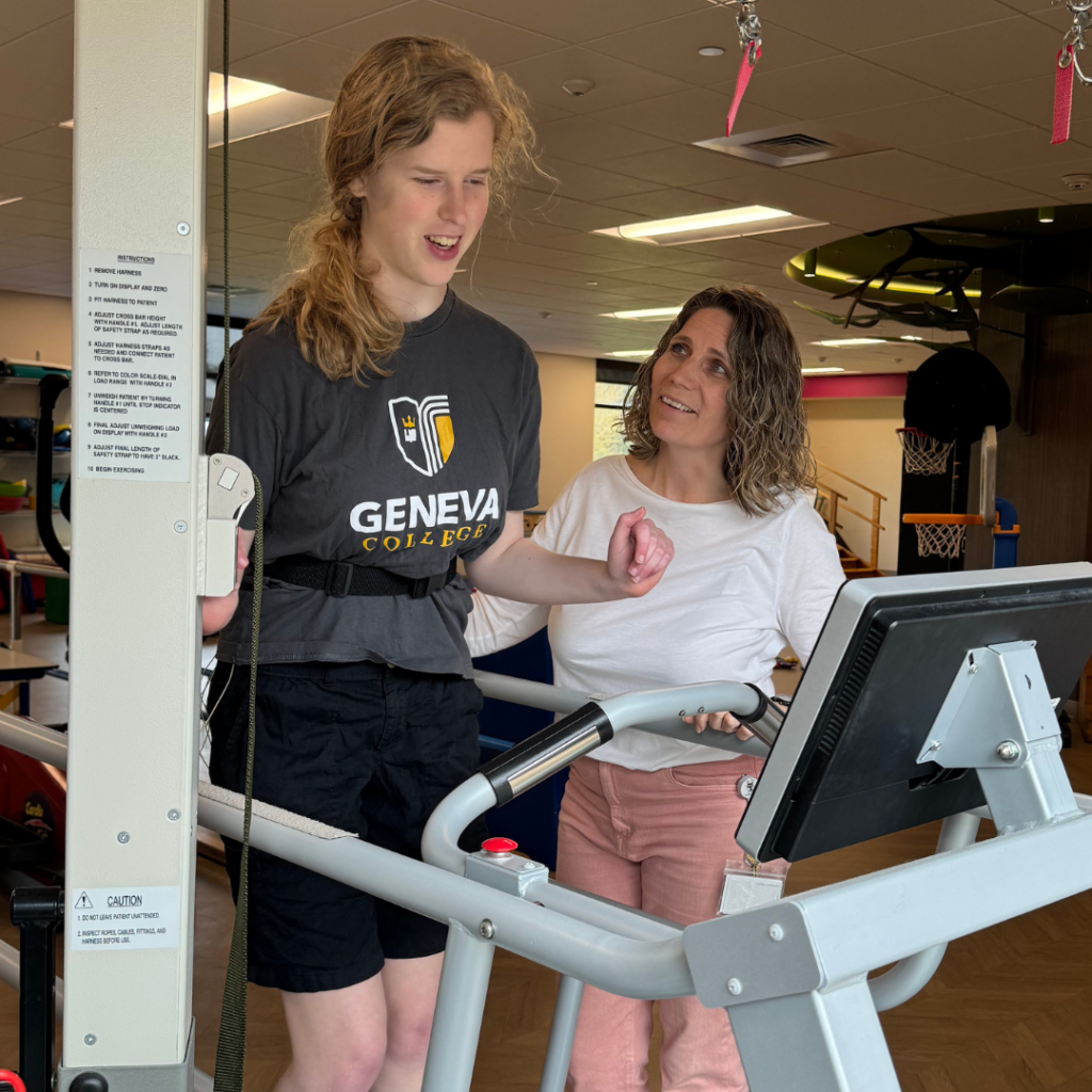 teenage girl on treadmill with therapist