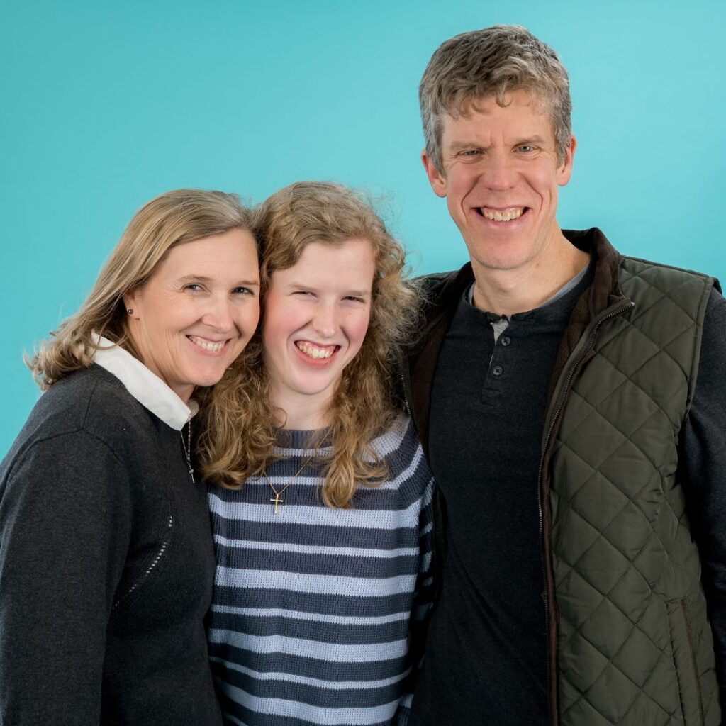 young woman surrounded by her mom and dad