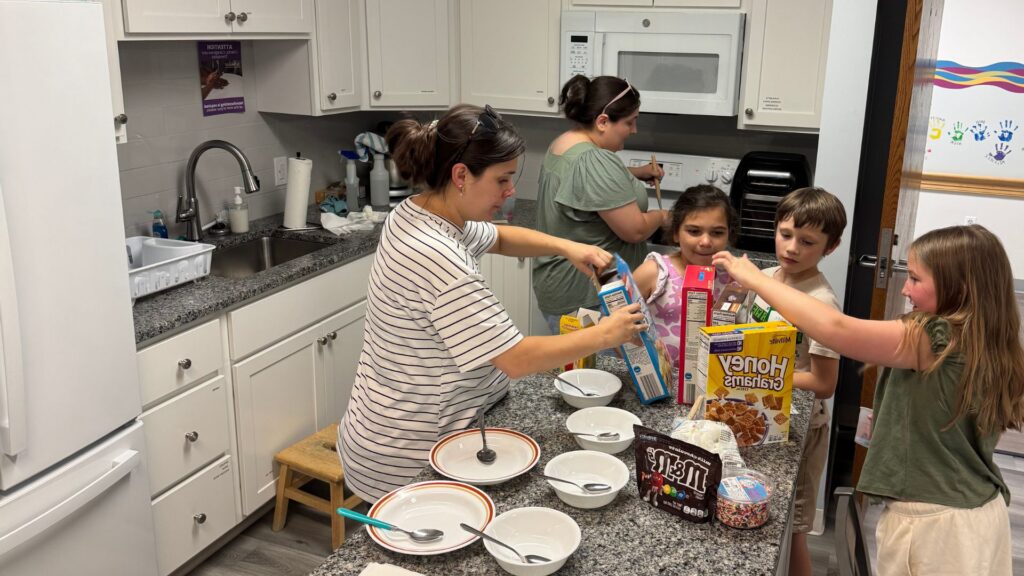 Schreiber Sibs group making their snack in the ADL room with the assistance of their adult group leaders